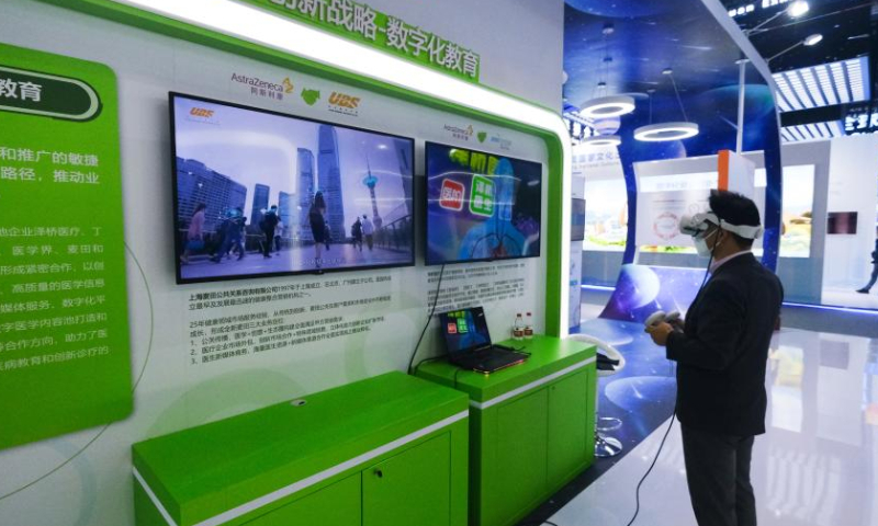 A visitor tries a digital learning service at the first Global Digital Trade Expo in Hangzhou, east China's Zhejiang Province, Dec. 11, 2022.The 4-day expo kicked off here on Sunday. Around 800 leading digital trade companies from China and abroad will showcase their new products and technologies during the expo. (Xinhua/Xu Yu)